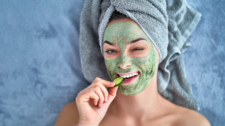 happy-cheerful-winking-woman-with-green-cleansing--------mask
